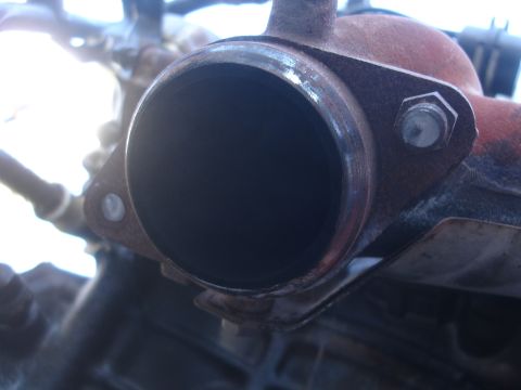 1993 Ford Taurus - This image shows a close-up view of an exhaust pipe connection, focusing on the flange and gasket.
