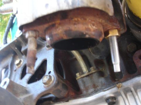 1993 Ford Taurus - Close-up view of a corroded engine exhaust manifold and associated hardware.