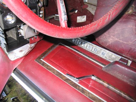 2001 Ford Crown Victoria - Photograph of a sedan's red interior console, not a technical document.