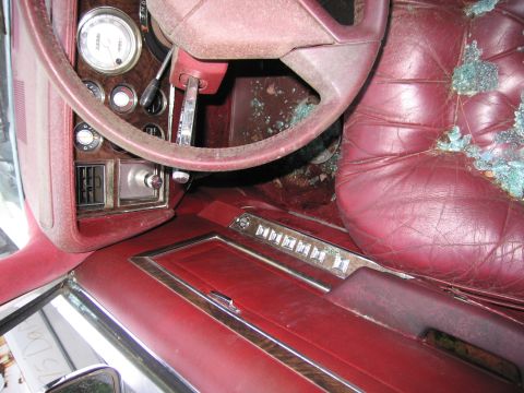 2001 Ford Crown Victoria - Photograph of a damaged sedan's red interior, not a technical document.