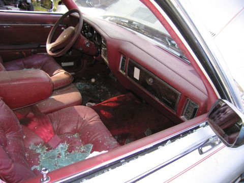 2001 Ford Crown Victoria - Photograph of a damaged sedan's red interior, not a technical document.