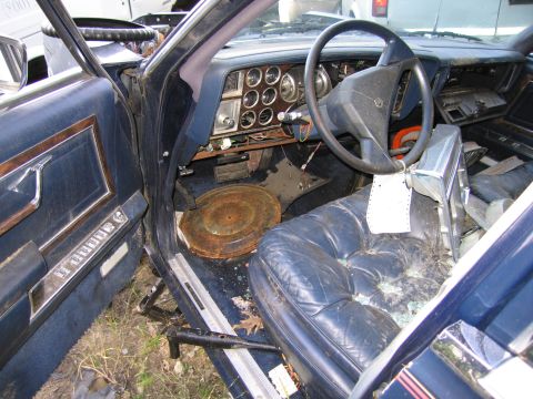 2001 Ford Crown Victoria - Photograph of a derelict Chrysler interior, not a technical document.