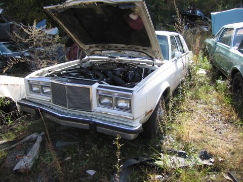 2001 Ford Crown Victoria - Photograph of a Chrysler sedan in a salvage yard, not a technical document.