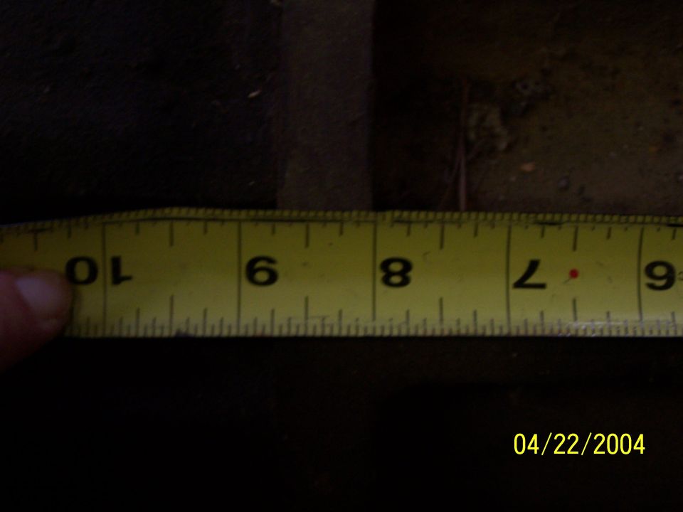 Close-up of a yellow measuring tape showing inches from 6 to 10. A finger is visible on the left side. Date stamp reads 04/22/2004