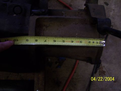 1979 Ford F-150 - A close-up view of a metal part with a measuring tape indicating its dimensions.