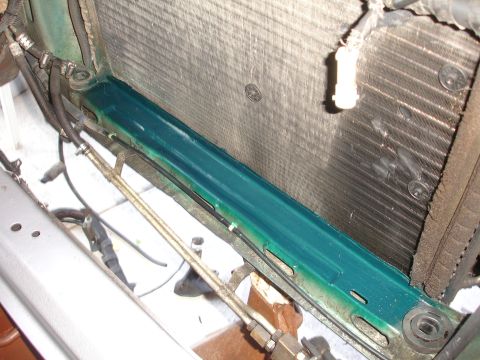 1993 Ford Taurus - Radiator and associated plumbing, showing green fluid residue on the support structure.