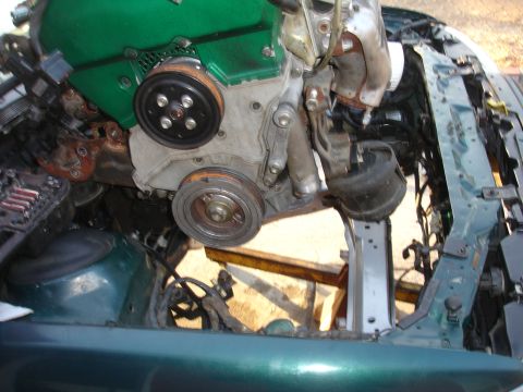 1993 Ford Taurus - The engine is partially removed from the vehicle's frame for repairs or modifications.