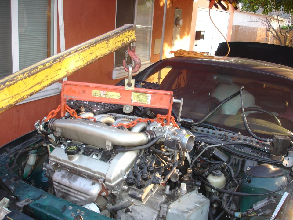 1993 Ford Taurus engine being lifted out by an engine hoist