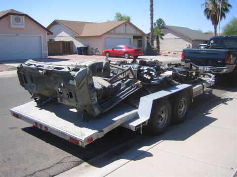1994 Ford Bronco - Car chassis being transported on a trailer.