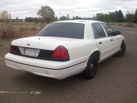 2000 Ford Crown Victoria - This 2000 Ford Crown Victoria is seen from the rear three-quarter angle, showing its white exterior and California license plate.