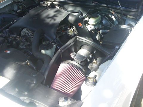 2000 Ford Crown Victoria - Aftermarket K&N FIPK cold air intake system installed in an engine bay.