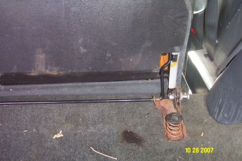 1992 Ford Bronco - Close-up of the back seat latch mechanism, showing the spring and metal rod, with a SuperMotors watermark at the bottom right.
