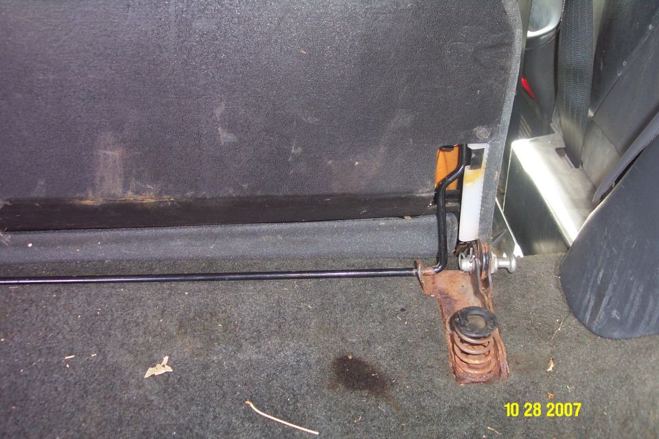 Back seat latch mechanism with spring and metal rod