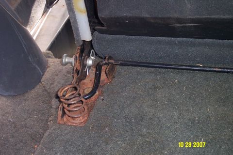 1992 Ford Bronco - Close-up of a rusted seat adjustment mechanism with visible springs and a lever.