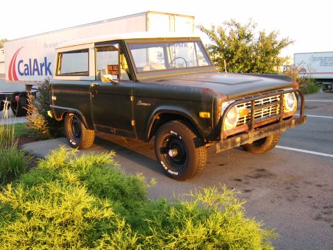 1976 Ford Bronco - This 1976 Ford Bronco is parked outdoors with a trailer behind it.