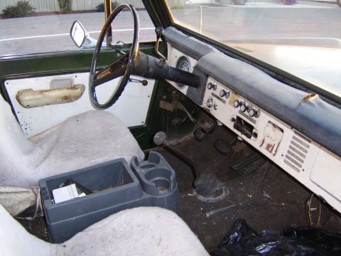1976 Ford Bronco - The interior of a 1976 Ford Bronco, its dashboard, steering wheel, and seating area.