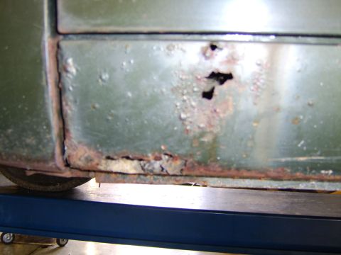 1976 Ford Bronco - Severe rust damage is visible on the lower body panel of this vehicle.