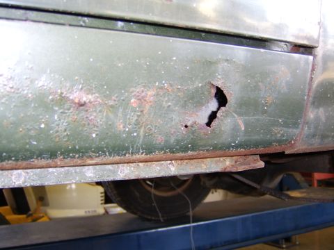 1976 Ford Bronco - The rocker panel of this vehicle shows significant rust damage and a hole through the metal.
