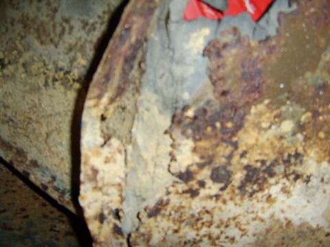 1976 Ford Bronco - Heavily corroded metal shows extensive rust damage, obscuring any identifying features.