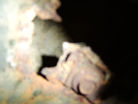 1976 Ford Bronco - Detail of corroded metal, showing signs of significant rust and wear.