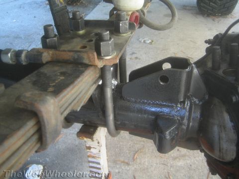 1987 Suzuki Samurai - Close-up view of a vehicle's leaf spring and axle assembly, showing suspension components.