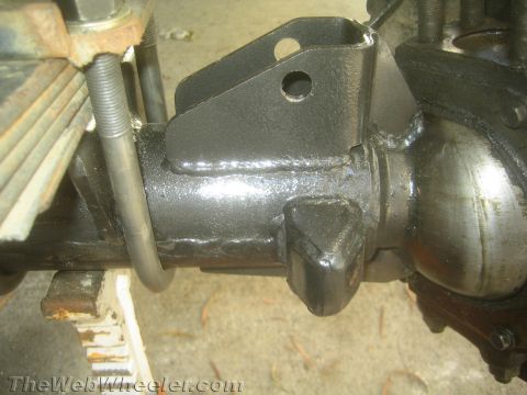 1987 Suzuki Samurai - Axle housing showing custom leaf spring mounts and U-bolt hardware, likely for a suspension modification.