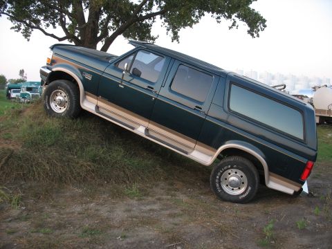 1995 Ford C-350 (Centurion Conversions) - This 1995 Ford C-350 Centurion Conversions is shown in a three-quarter front view, parked on an incline.