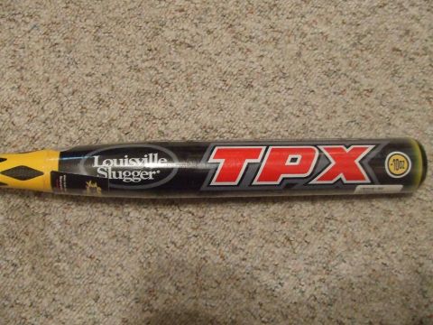 1987 Ford Bronco - A Louisville Slugger TPX baseball bat is shown lying on a carpeted surface.
