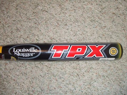 1987 Ford Bronco - A Louisville Slugger TPX baseball bat is shown lying on a carpeted surface.