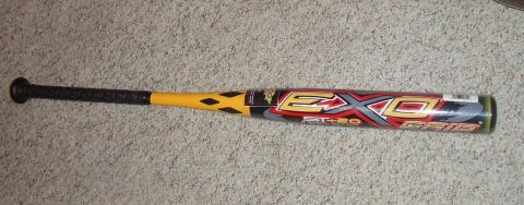 1987 Ford Bronco - A baseball bat with a yellow handle and barrel is lying on a carpeted surface.