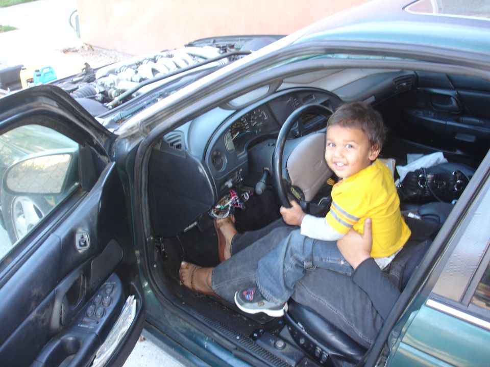 Interior of a 1993 Ford Taurus with a child in the driver's seat