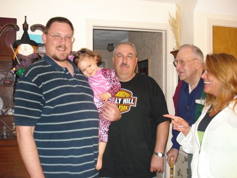 2000 Ford Crown Victoria - A group of people, including adults and a child, are gathered together for a photograph.