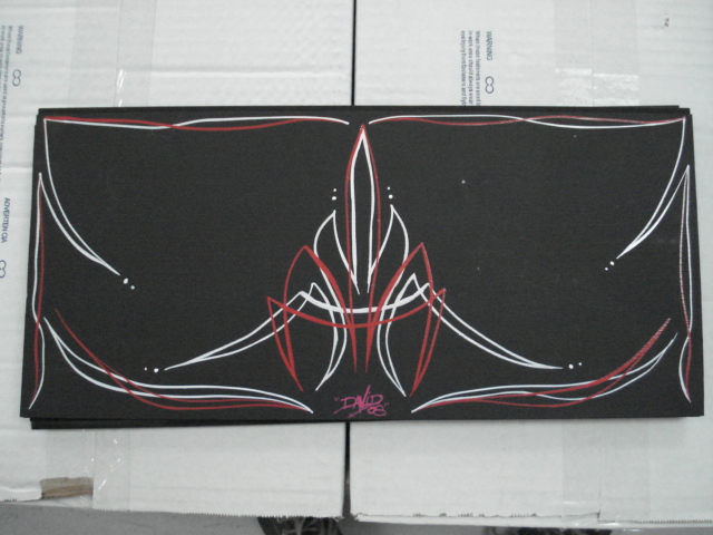 Black panel with red and white pinstripe art and a signature