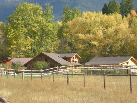 1974 Ford Ranchero - A scenic view of houses and autumn trees, with a fence and dry grass in the foreground.
