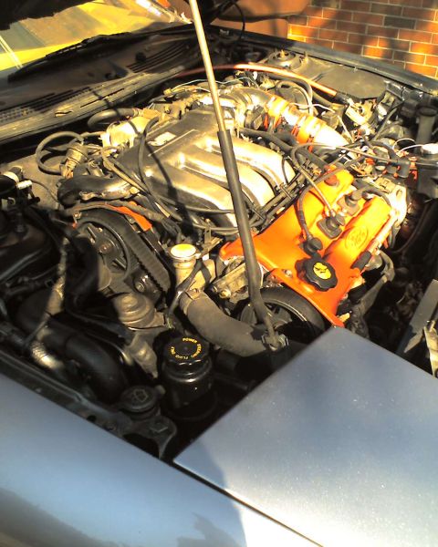 1994 Ford Probe - Close-up view of an engine bay, showing various components and the timing belt.
