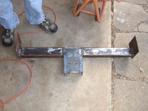 1996 Ford F-150 - A custom-fabricated transmission crossmember is shown, likely for a truck or SUV, with visible welds and mounting plates.
