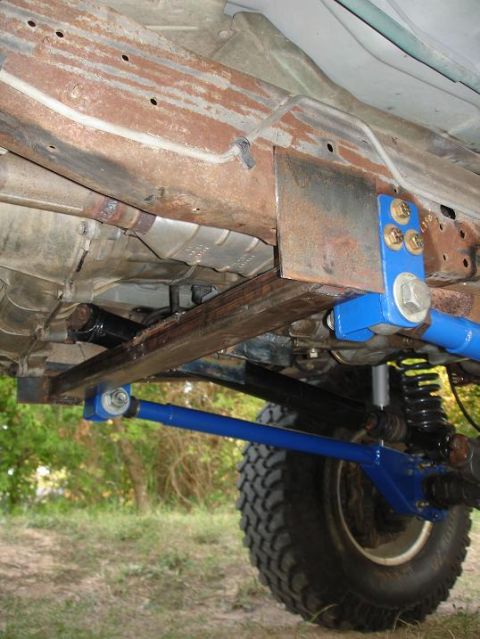 1996 Ford F-150 - Aftermarket blue suspension components are visible on the underbody of a truck, suggesting modifications beyond the original factory specif…
