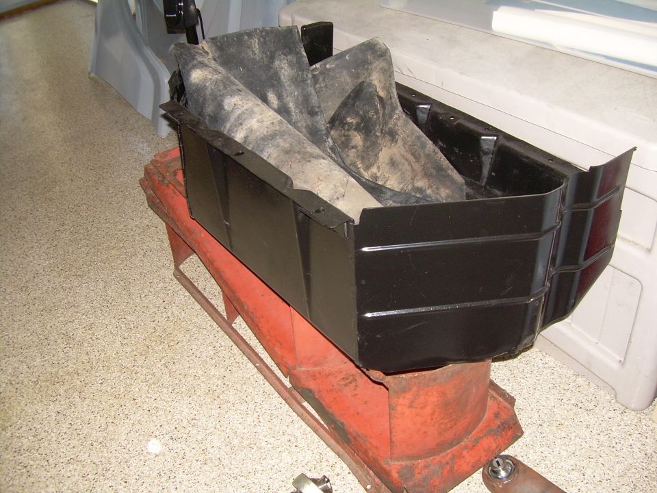 Black skid plate with rubber flaps, mounted on red stand