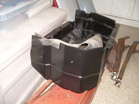 1986 Ford Bronco - A black plastic skid plate and several metal brackets are shown, possibly for a vehicle.