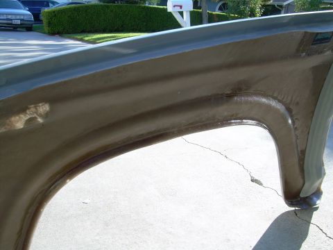 1986 Ford Bronco - Close-up view of the inside of a vehicle's fender well, showing the construction and mounting points.