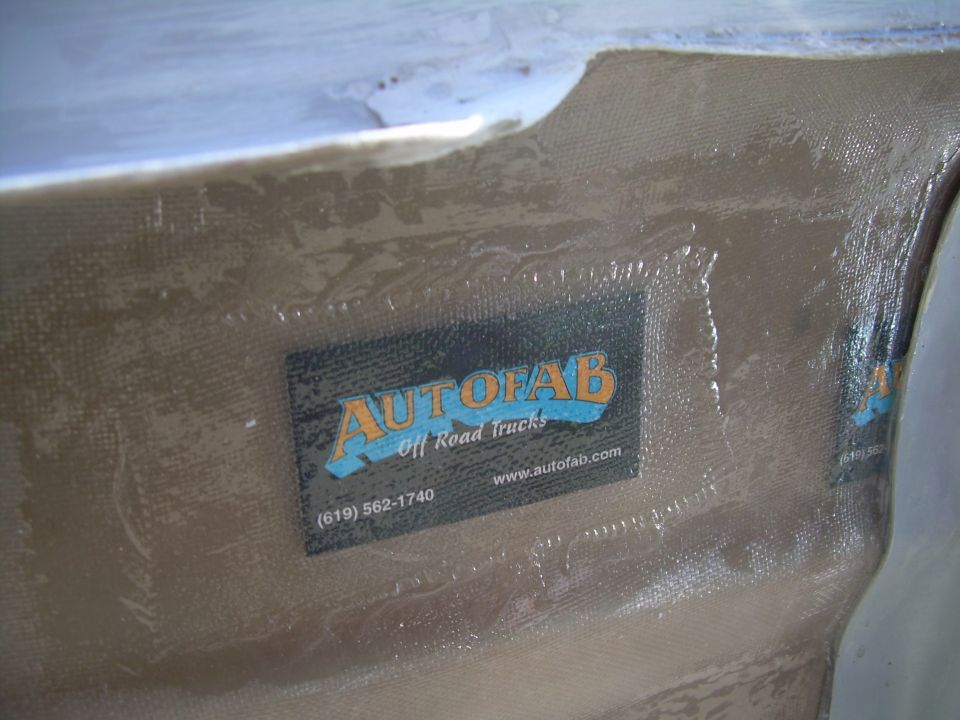 Autofab Off Road Trucks sticker on a fiberglass part, with website and phone number visible