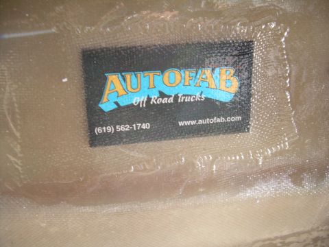 1986 Ford Bronco - A business card for Autofab Off Road Trucks is affixed to a textured surface.