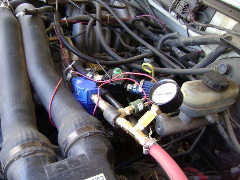 1988 Ford Bronco - A fuel pressure gauge is connected to the engine bay, showing a blue fuel filter and various hoses.