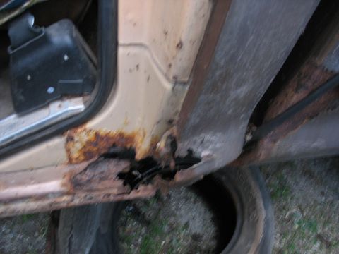 1978 Ford F-250 - Severe rust damage is visible on the door sill and lower body panel of this vehicle.