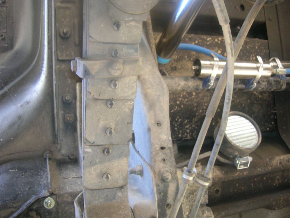 Vehicle suspension system with leaf springs and shock absorber, dusty.