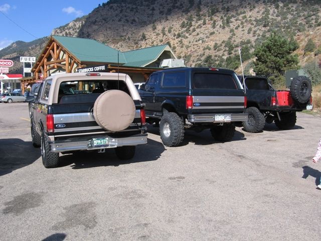 Lifted dark Ford Bronco parked in front of Starbucks.