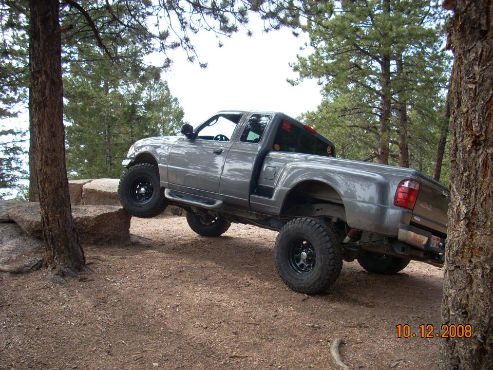 Lifted gray Ford Ranger pickup truck on rocks off-road