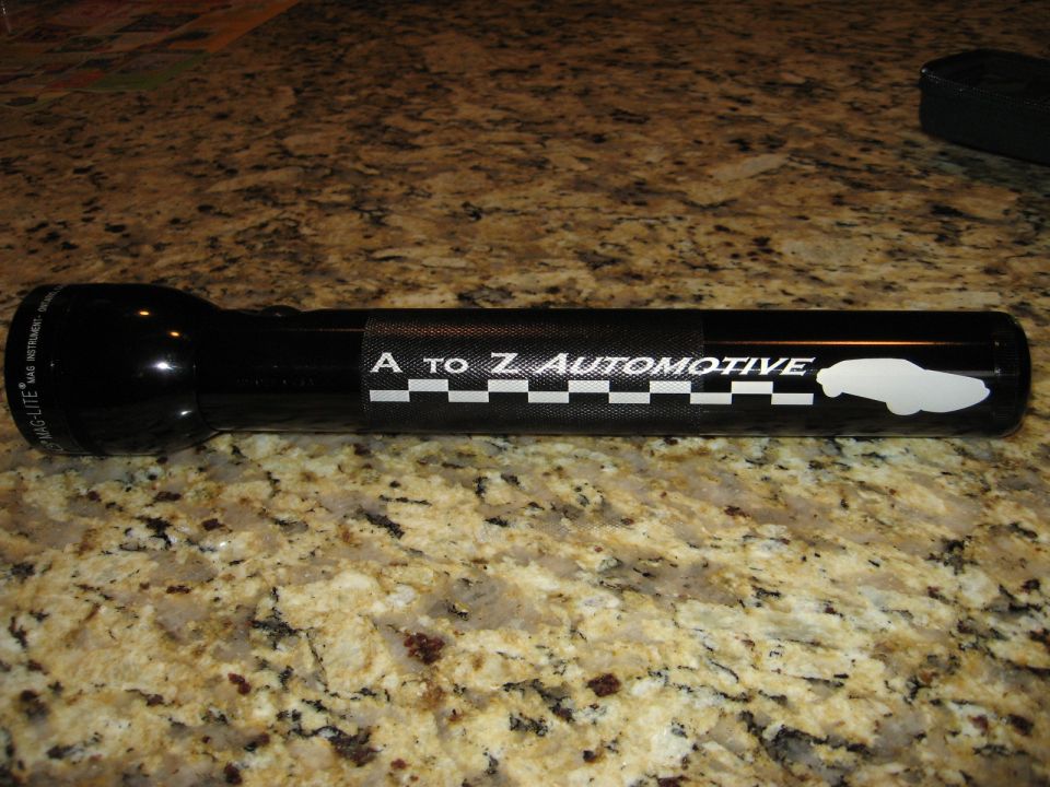 Black Maglite flashlight with "A to Z Automotive" logo and car silhouette.