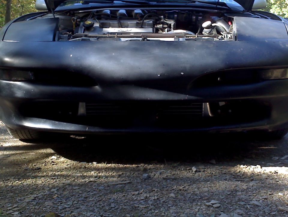 Black 1993 Ford Probe front view, hood open, engine visible, parked outdoors.