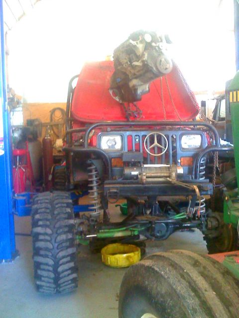 1992 Ford Bronco - Rear view of a tractor, showing its large tires and red lights.